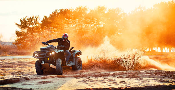 Teen riding ATV in sand dunes making a turn in the sand Exploring Adventure Tourism with Polaris India